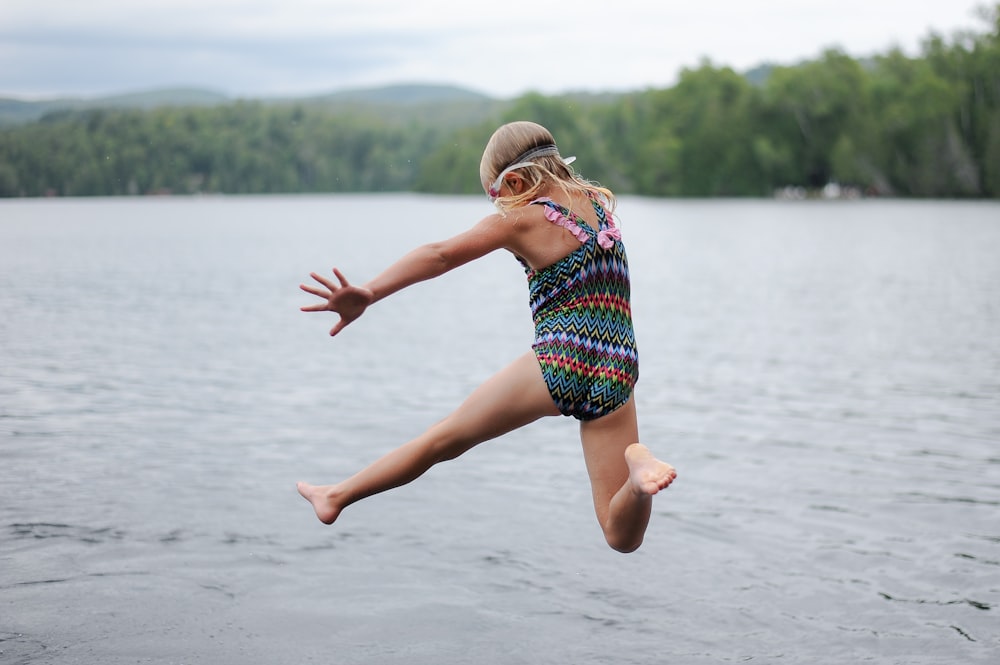 girl skipping on body of water