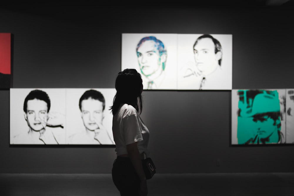 woman wearing shirt while watching photo