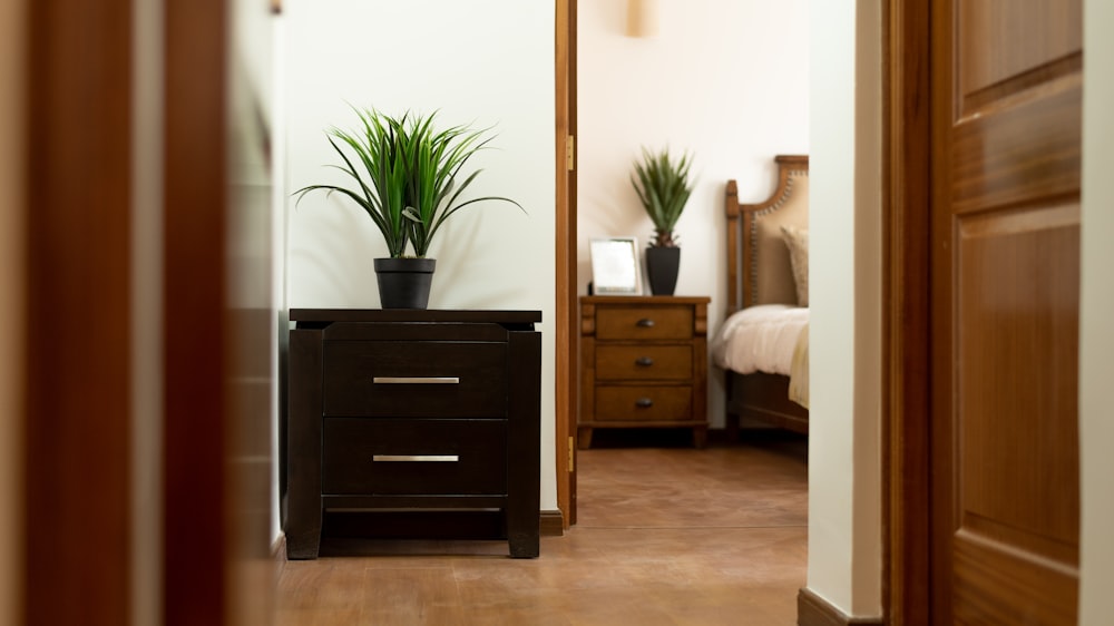 brown wooden nightstand beside doorway inside room