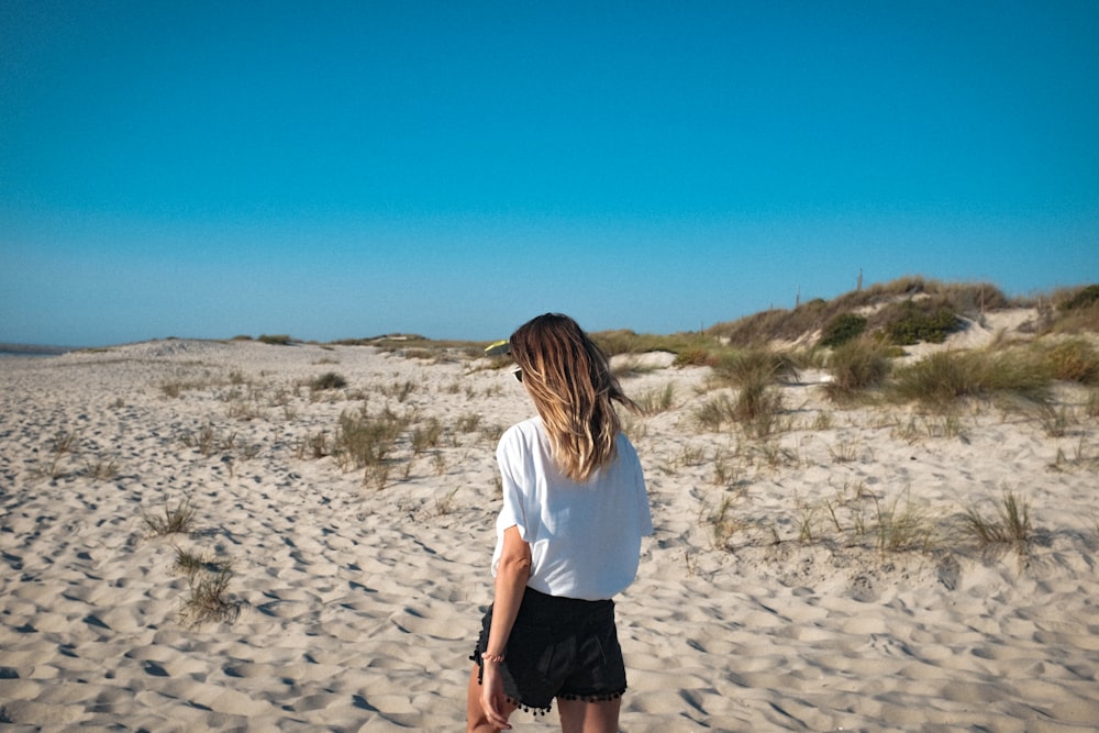 woman walking on sand pavement