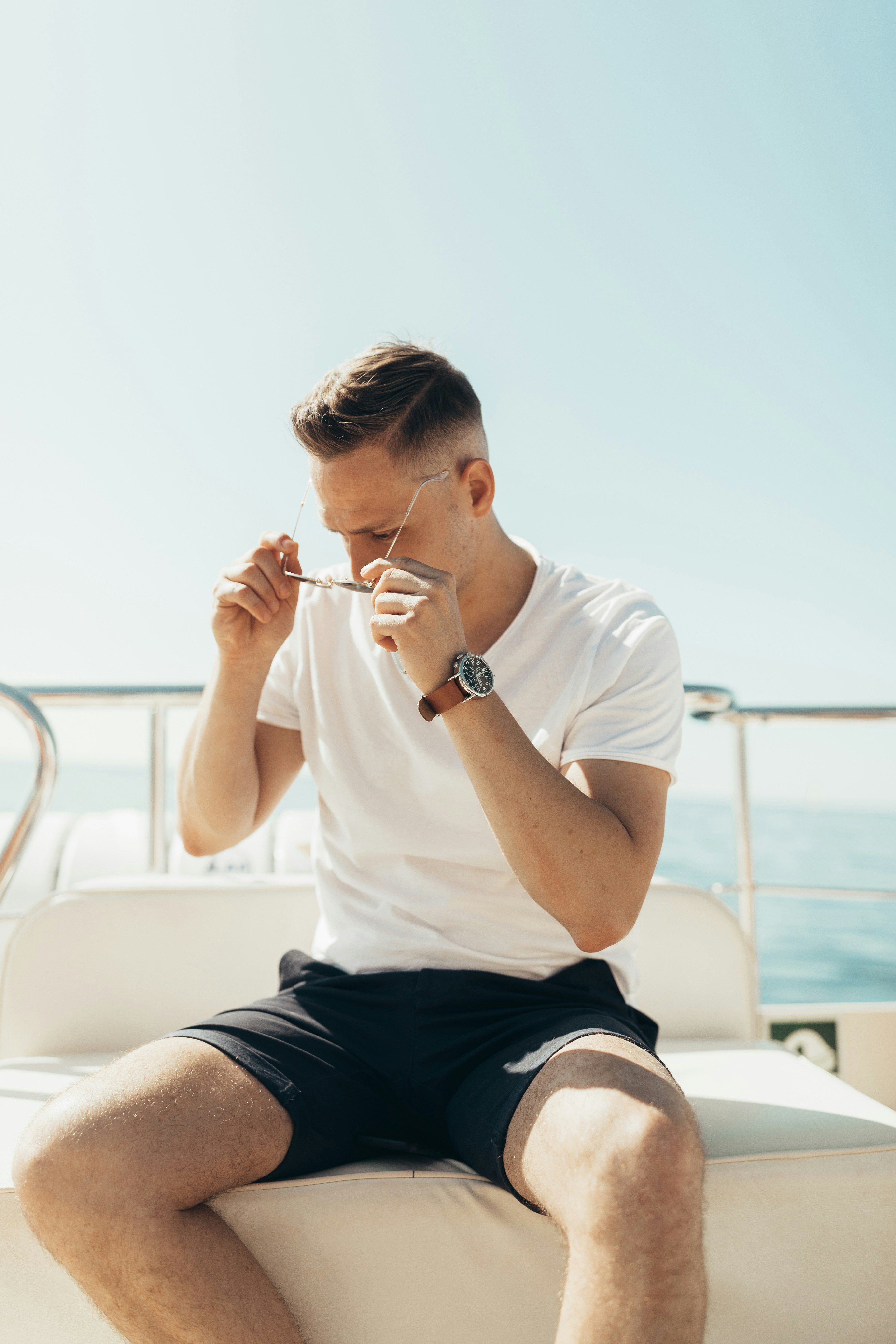 man trying to wear sunglasses