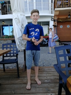 A customer walking barefoot on a sunlit wooden deck wearing bamboo sandals.