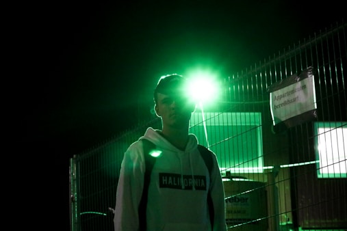 A cozy hoodie with glowing reflective text in a nighttime urban setting