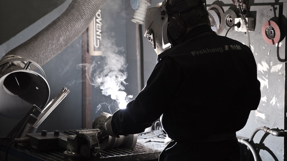 man in working suit welding metal