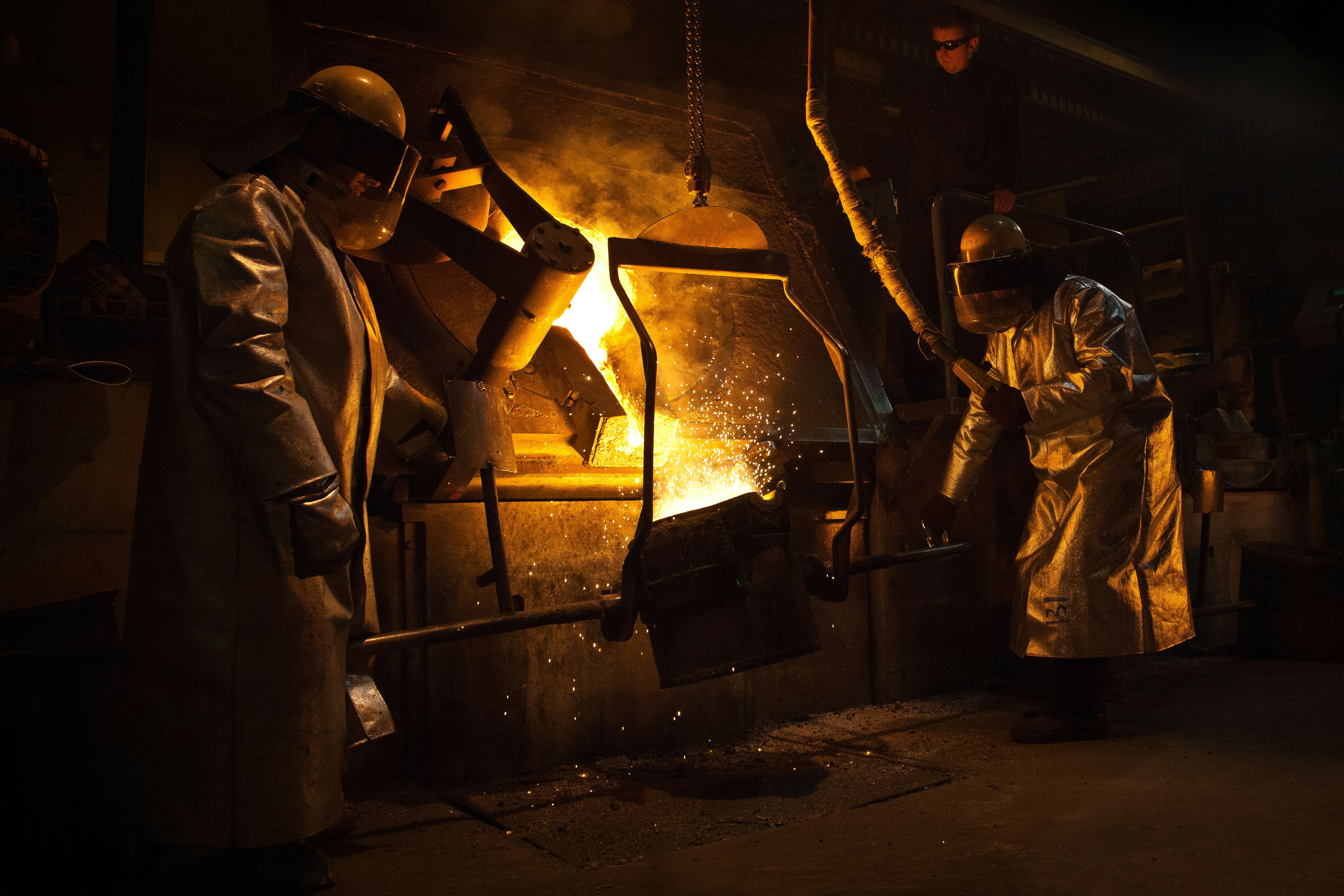 Dos personas sosteniendo un contenedor de metal cerca de la ilustración del fuego