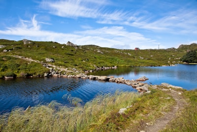 Plot of land near a small lake with clear water and natural surroundings.