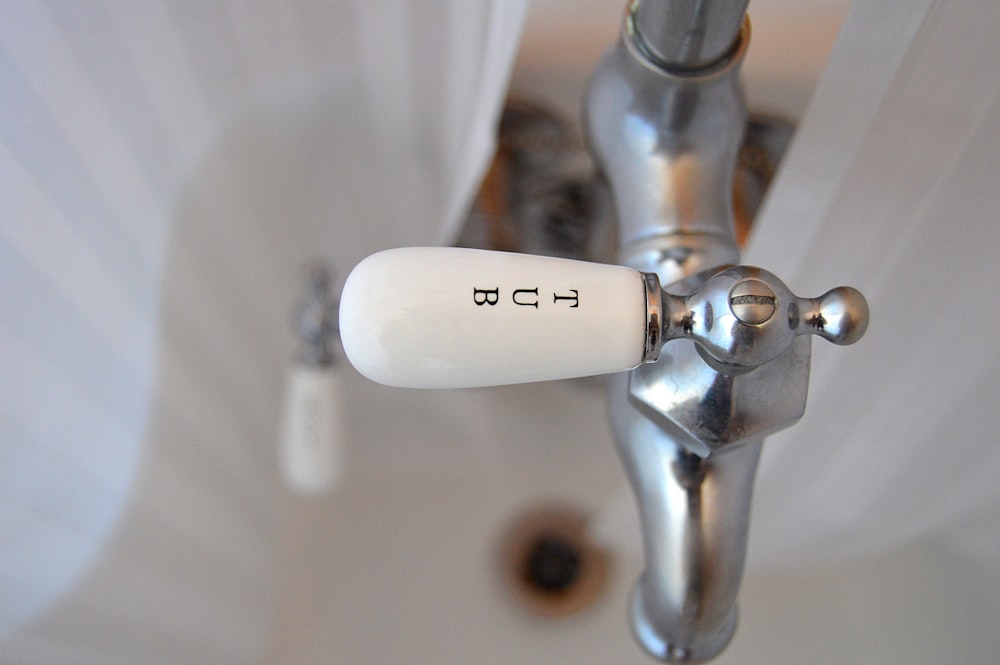 shallow focus photography of faucet