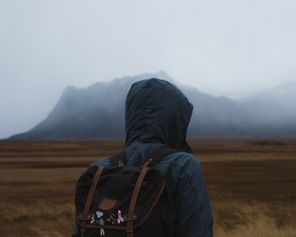 man carrying black knapsack