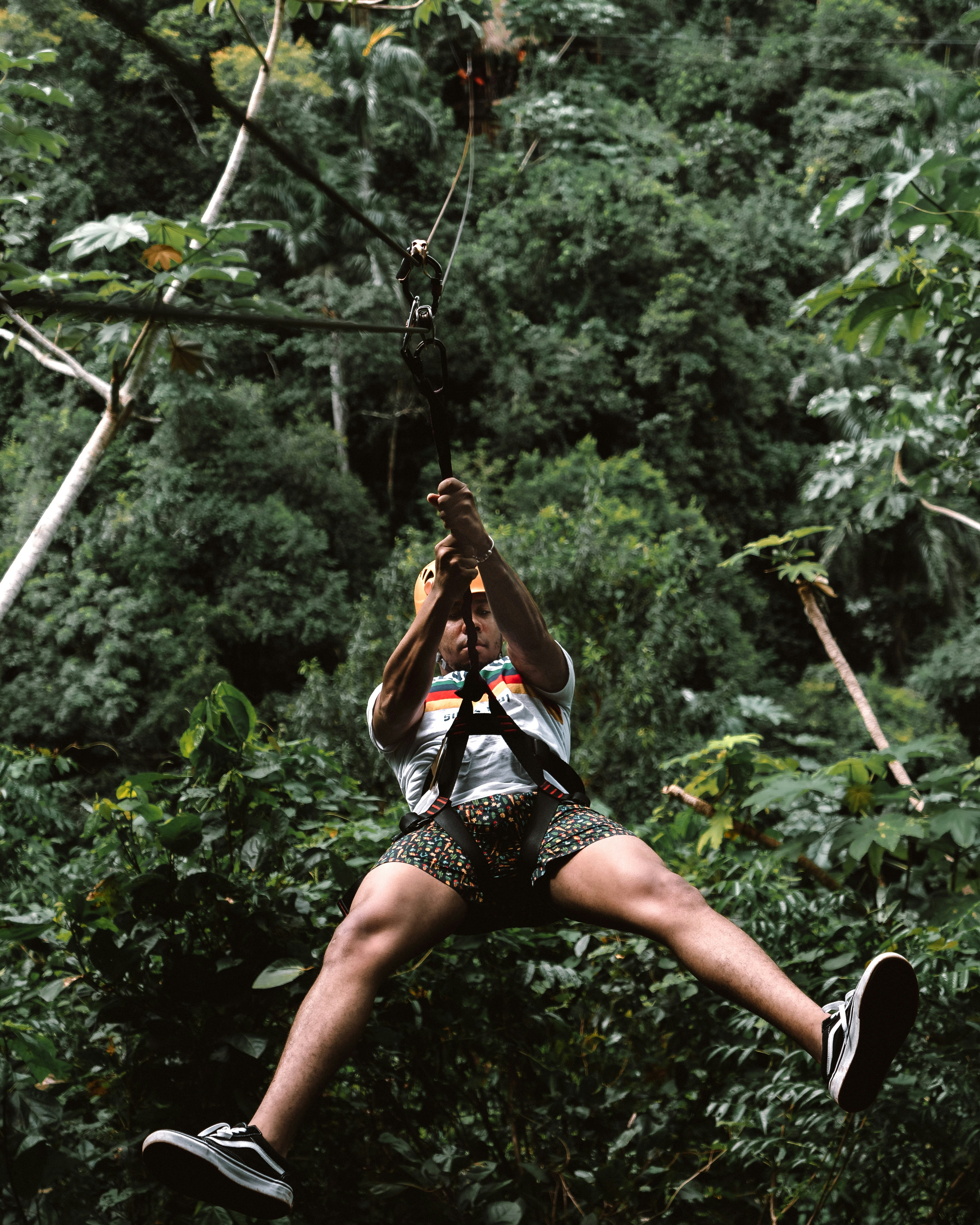 man riding zip line