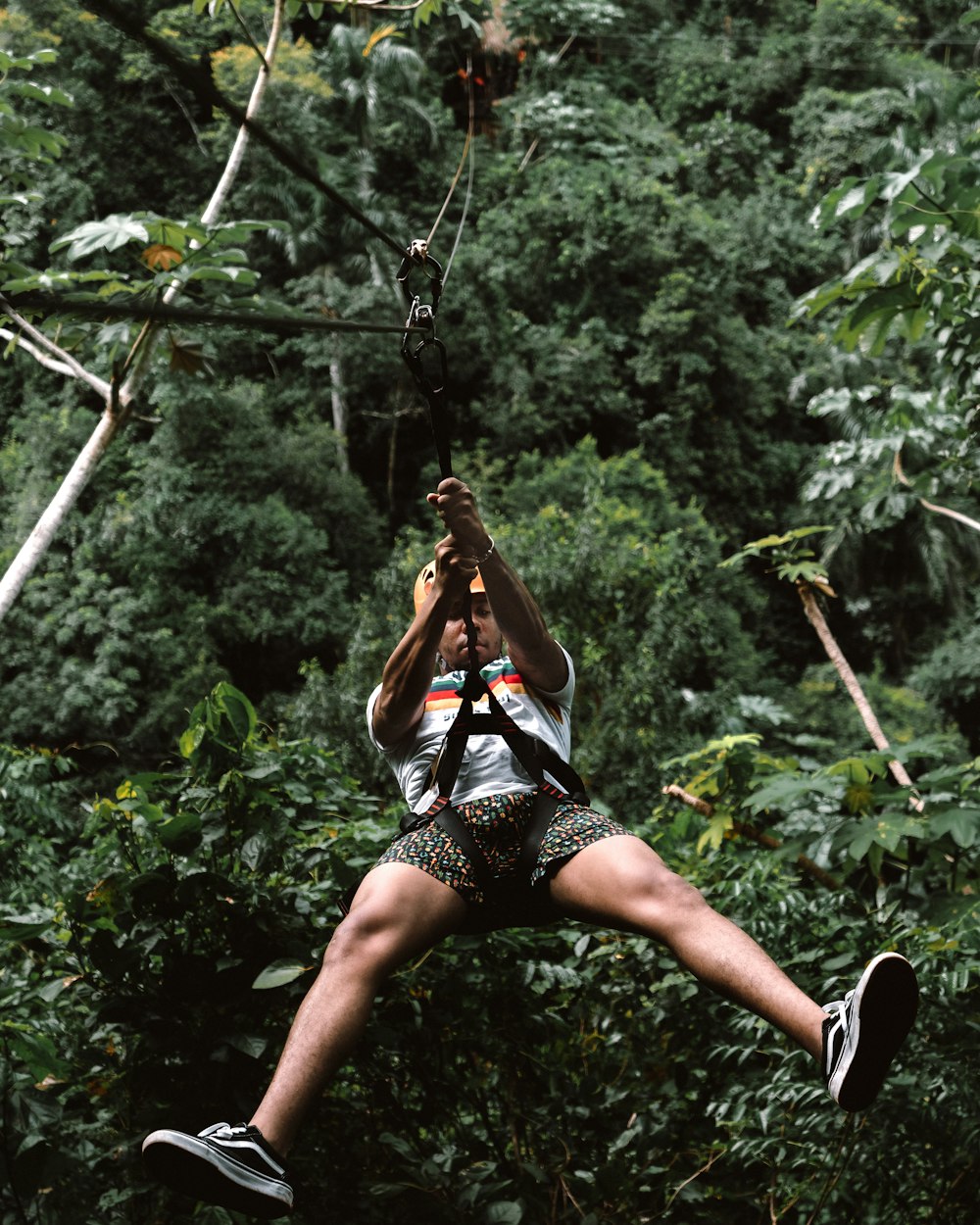 man riding zip line