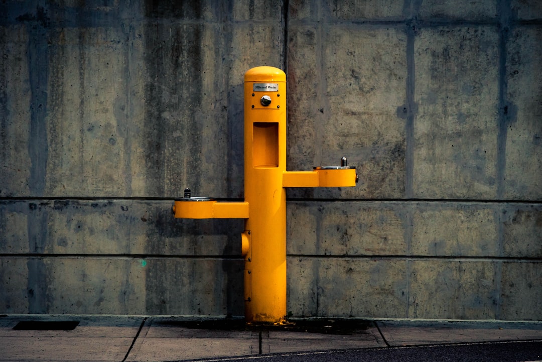 yellow pedestal outdoor post against wall