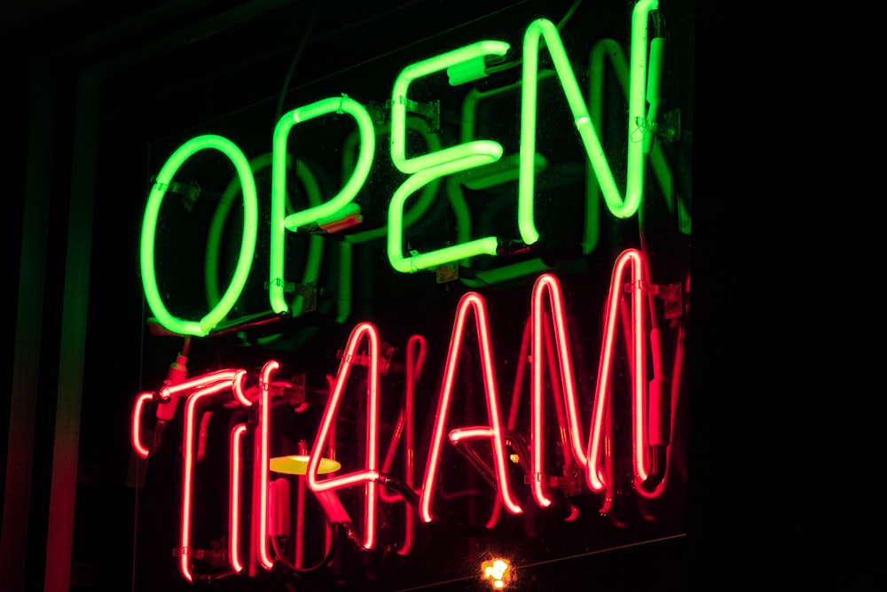 low-light photo of open til 4 AM neon sign