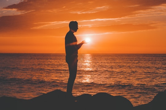 silhouette of man standing near sea shore in Asilah Morocco