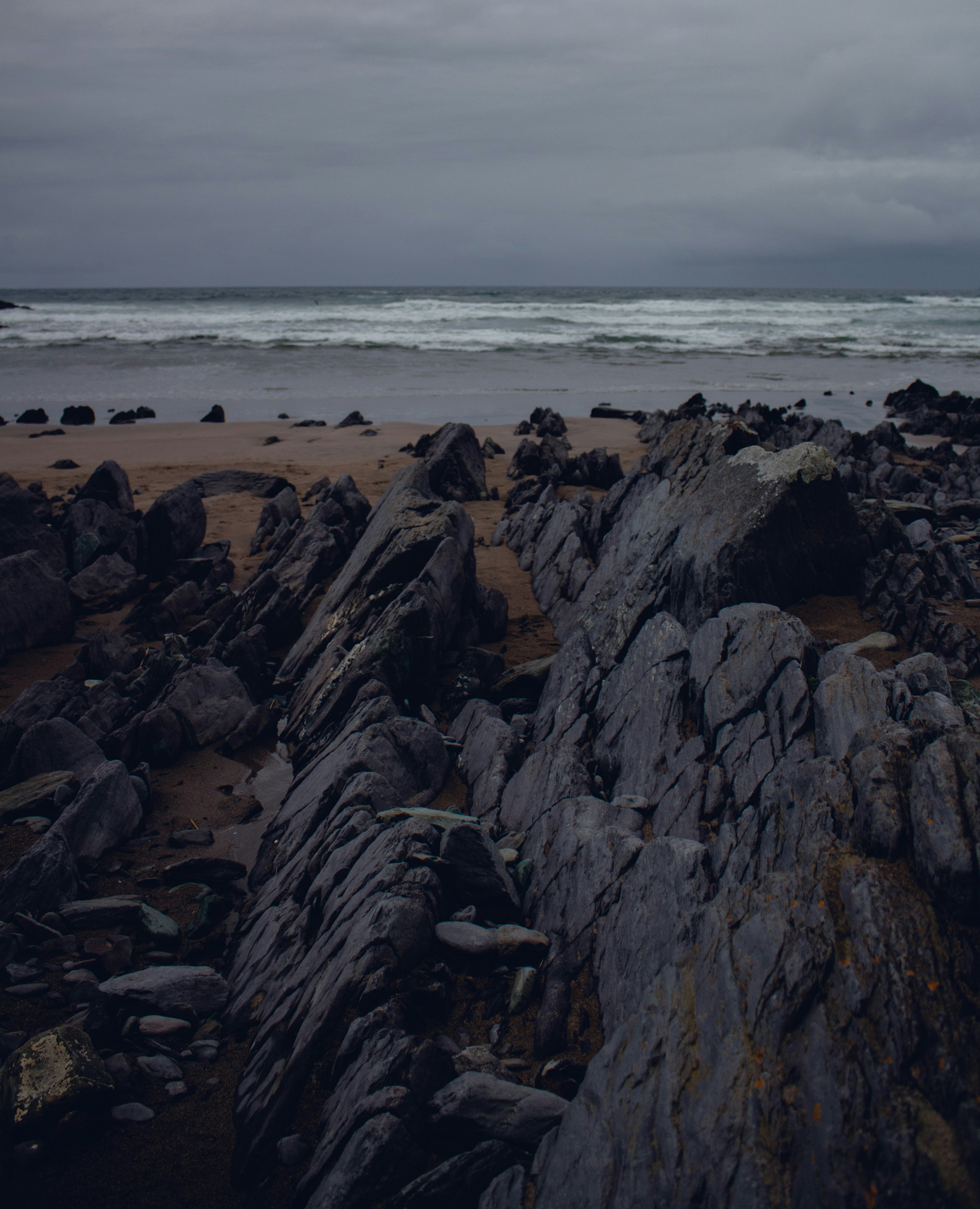 Gray rock near beach line photo – Free Sea Image on Unsplash
