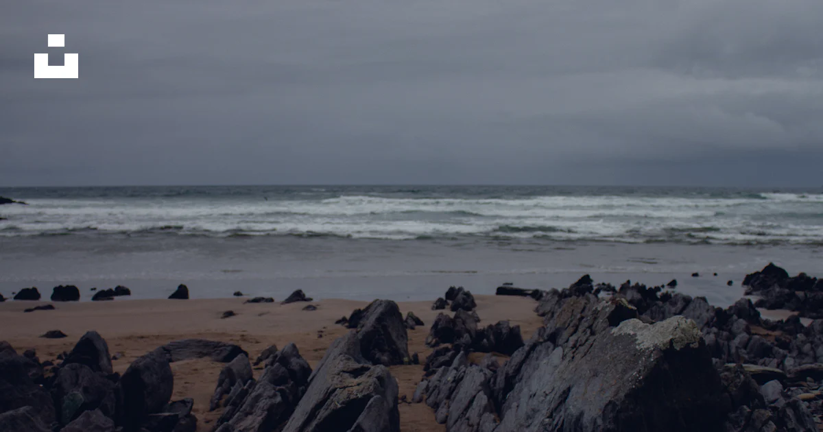 Gray rock near beach line photo – Free Sea Image on Unsplash