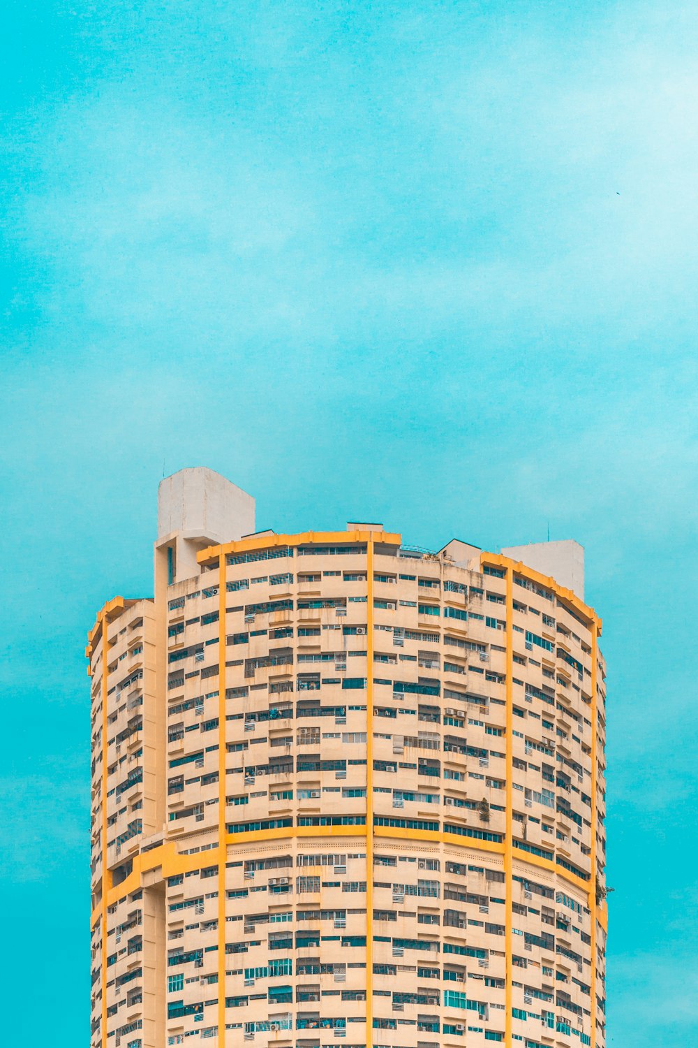 cylindrical high-rise building during daytime