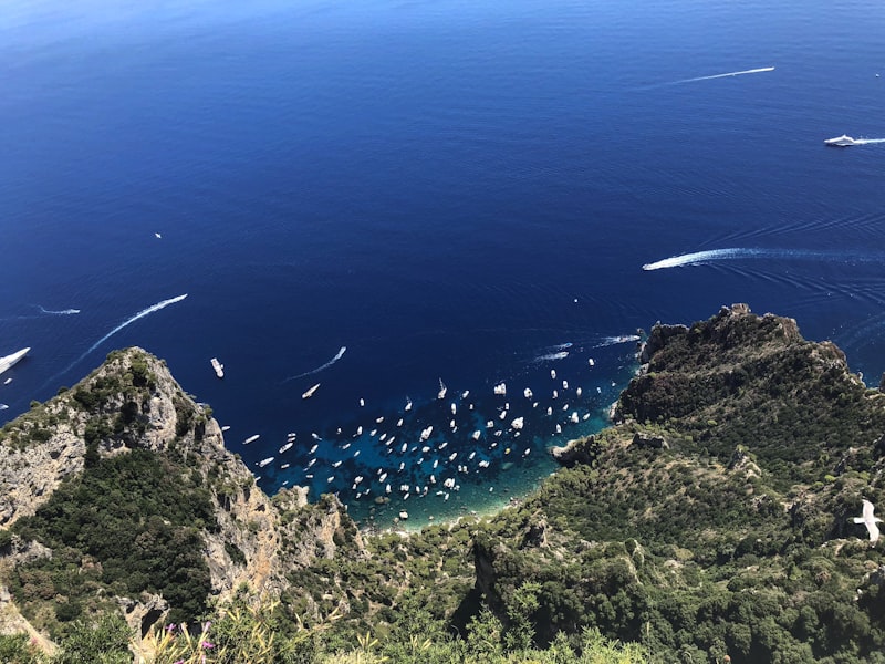 Boats sailing near the Faraglioni rock formations off Capri island