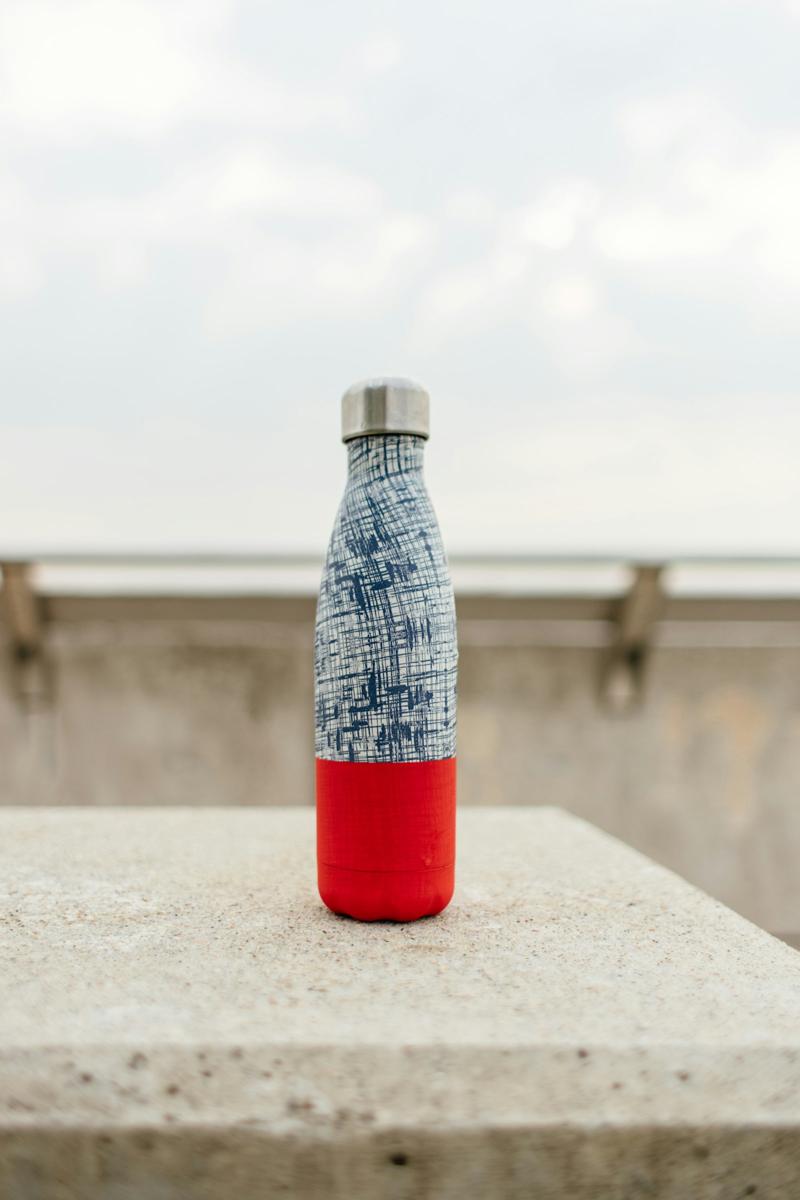 Sony a7 II + Canon EF 28mm F1.8 USM sample photo. Gray and red bottle photography