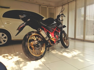 A sleek pre-owned motorcycle gleaming under natural light, parked in a garage with tools hanging on the wall.