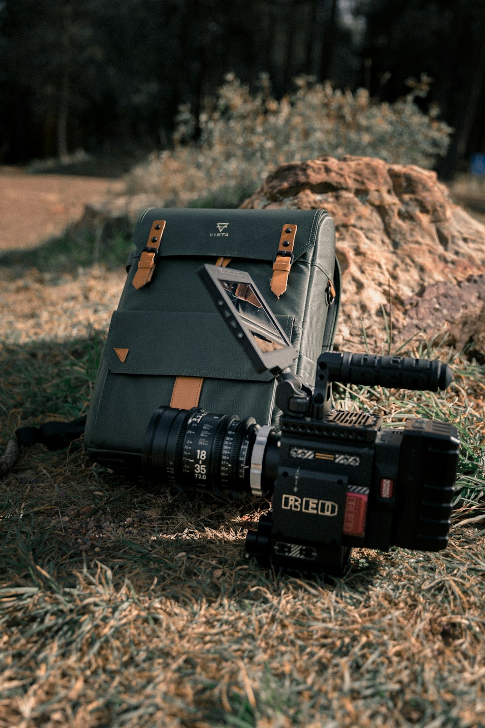 Black video camera and gray bag laying on grass photo – Free Grey Image on  Unsplash