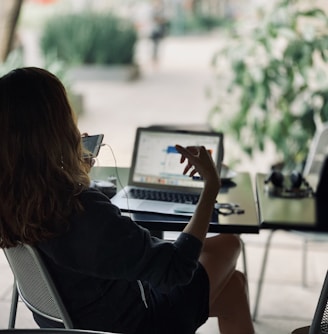 woman sitting on chair in front of table with laptop