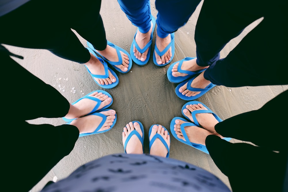 six people wearing blue flip-flops