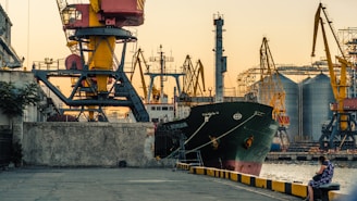 black cargo ship beside dock