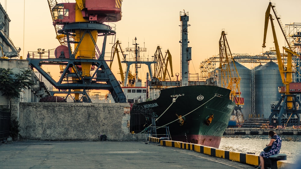 black cargo ship beside dock