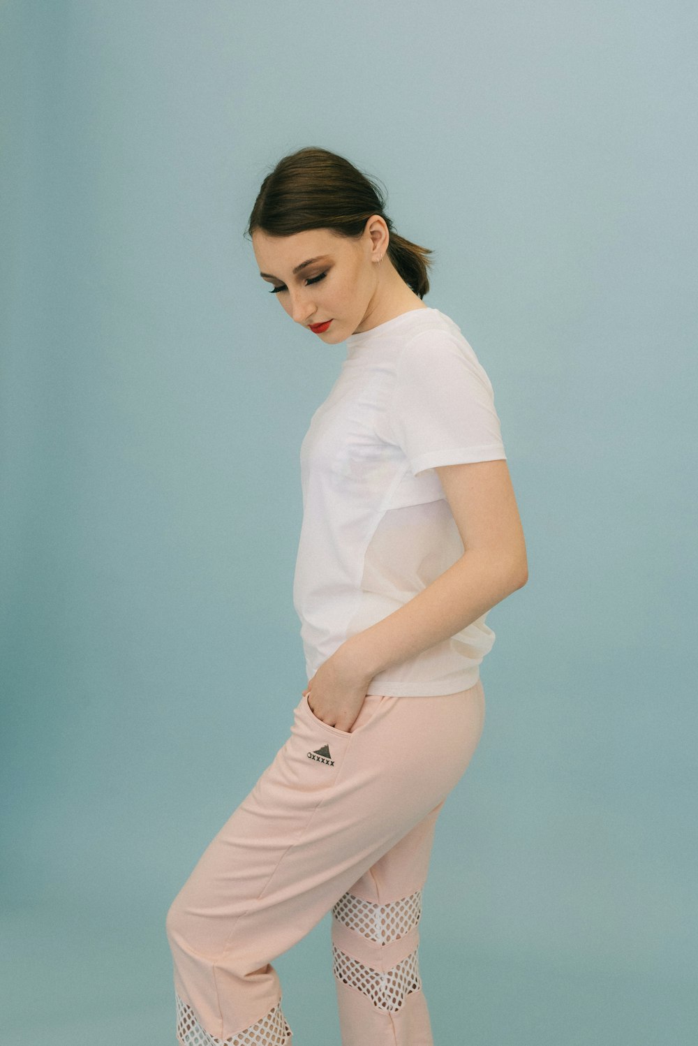 woman standing in front of blue wall