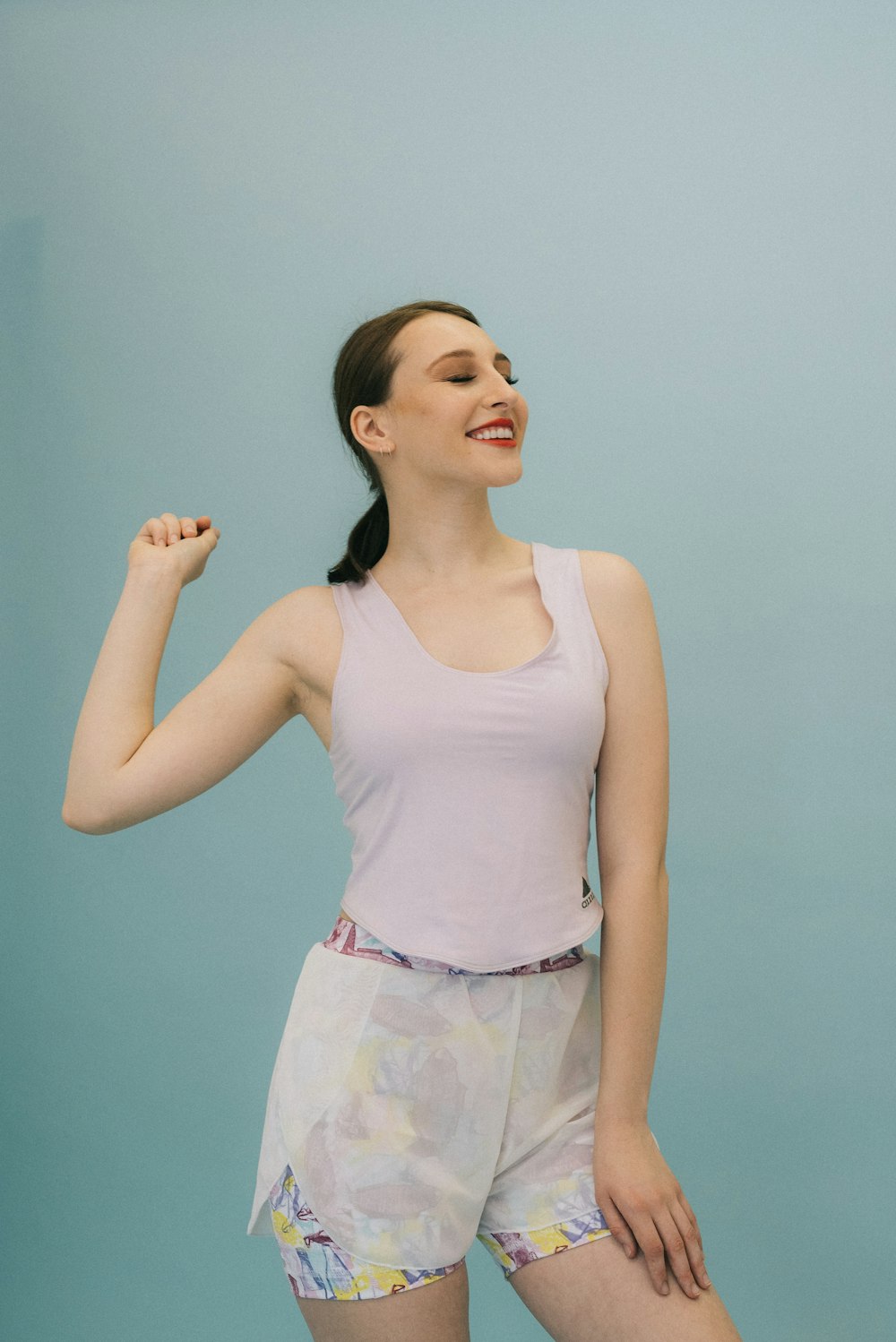 woman standing near teal wall