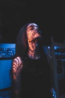 woman in black sleeveless shirt with boy artwork