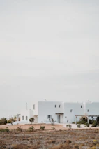 A panoramic view of the Isle of North Uist with a minimalist house blending into the natural landscape.