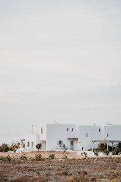 Minimalist white facade of a modern architectural home under soft natural light.