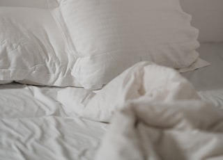 white bed pillow against white wall