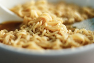 A close-up of the soft sticky noodles served in a rich, flavorful broth.