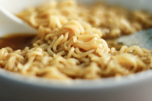 A close-up of the soft sticky noodles served in a rich, flavorful broth.