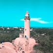 people on gray and white lighthouse