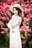 woman wearing dress standing beside pink flowers