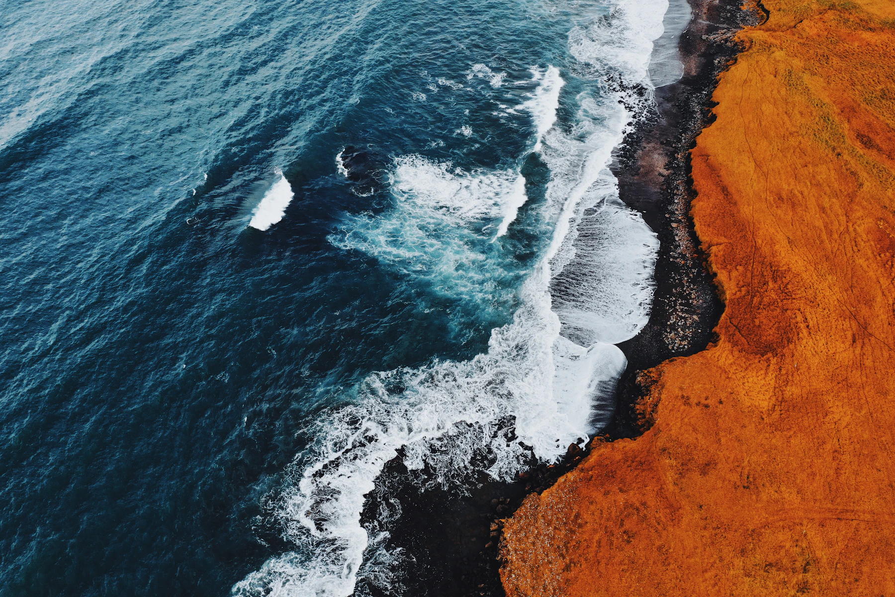 Volcanic shoreline and white surf