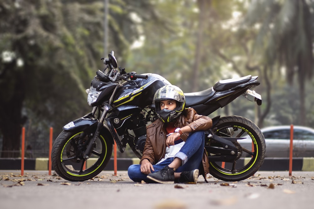 person sitting in front of black sports bike