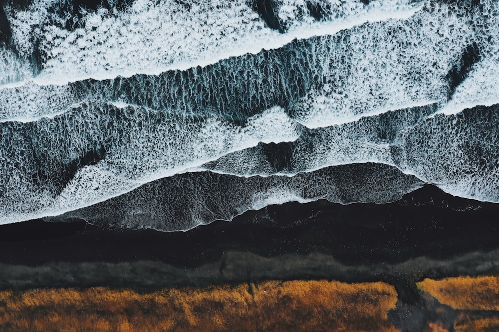 an aerial view of a beach with waves crashing on it