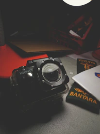 Close-up of a security badge beside a tactical headset on a dark desk.