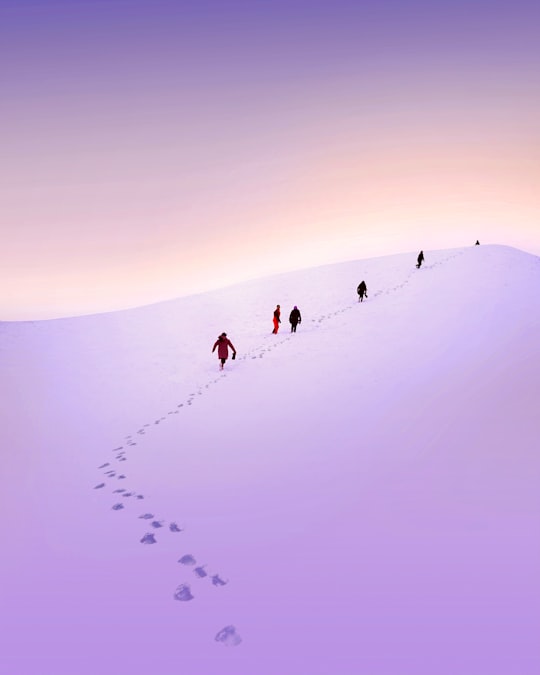 group of people walking snow field in Laza Azerbaijan
