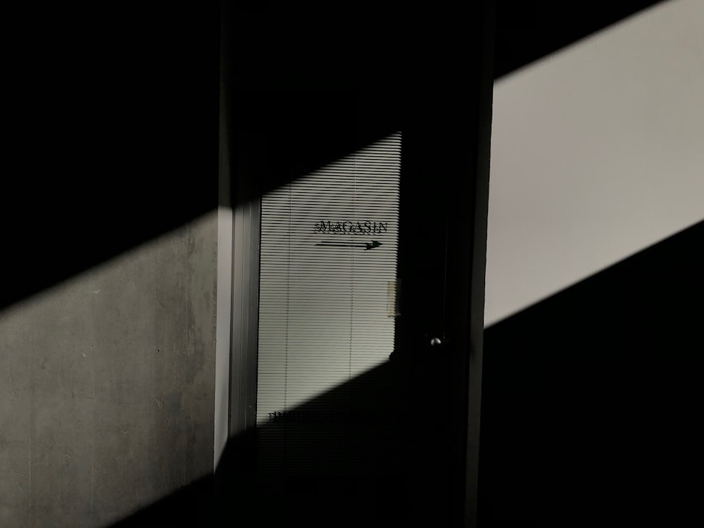a door with a sign on it in a dark room