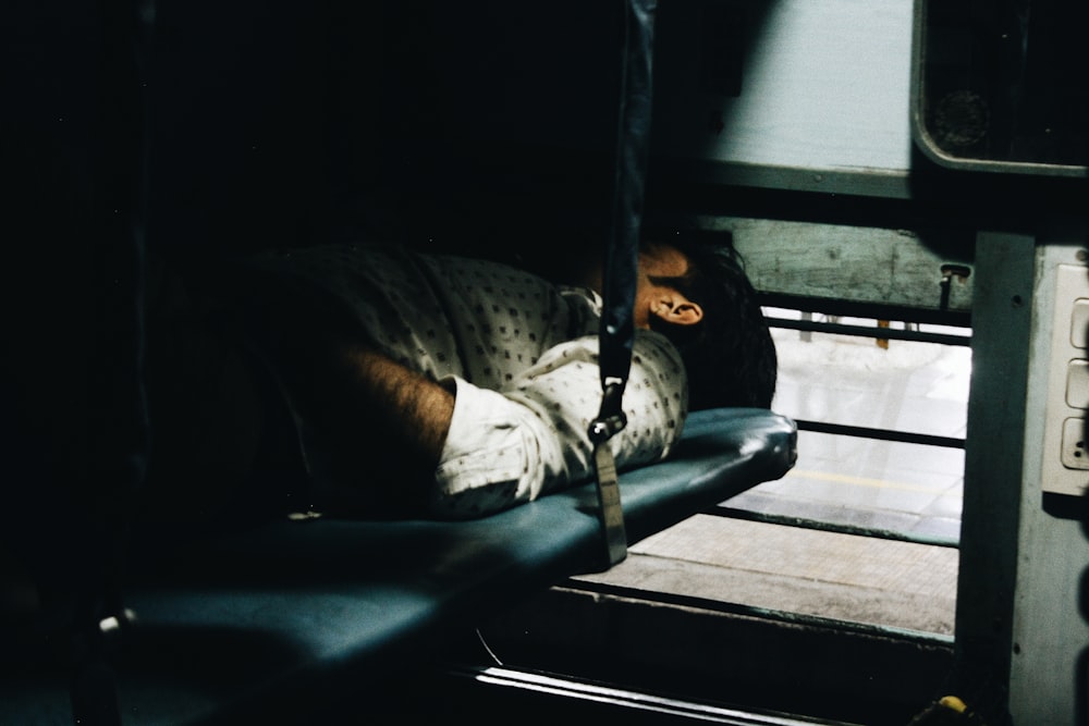 man lying on the blue textile