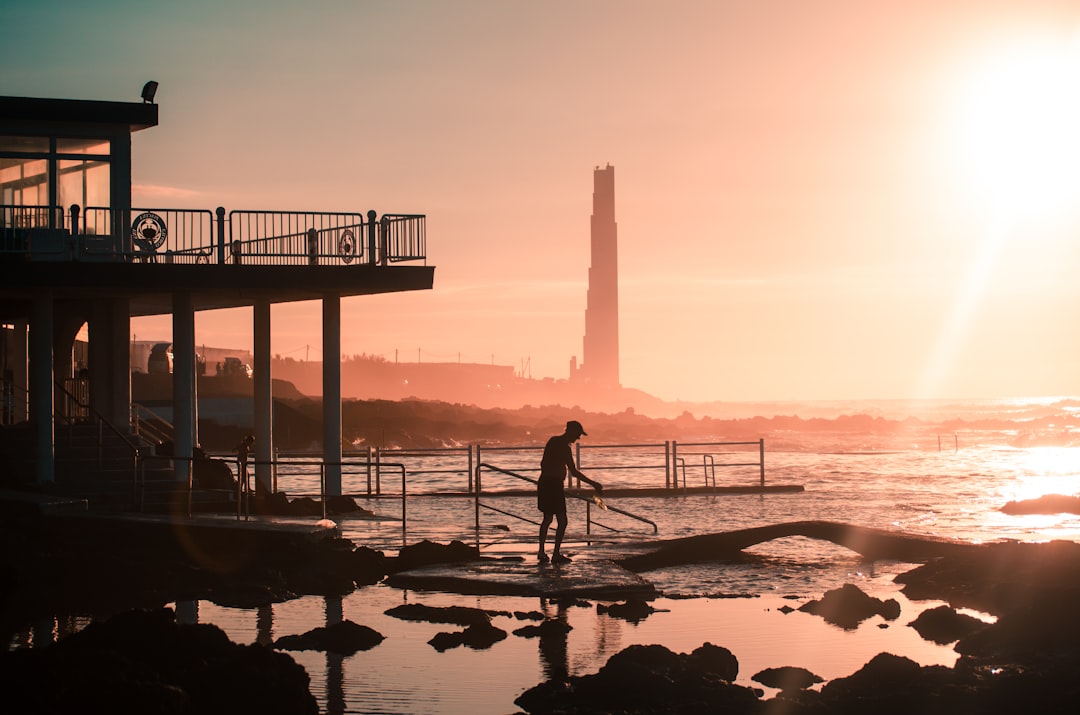 silhouette of person standing near handrails