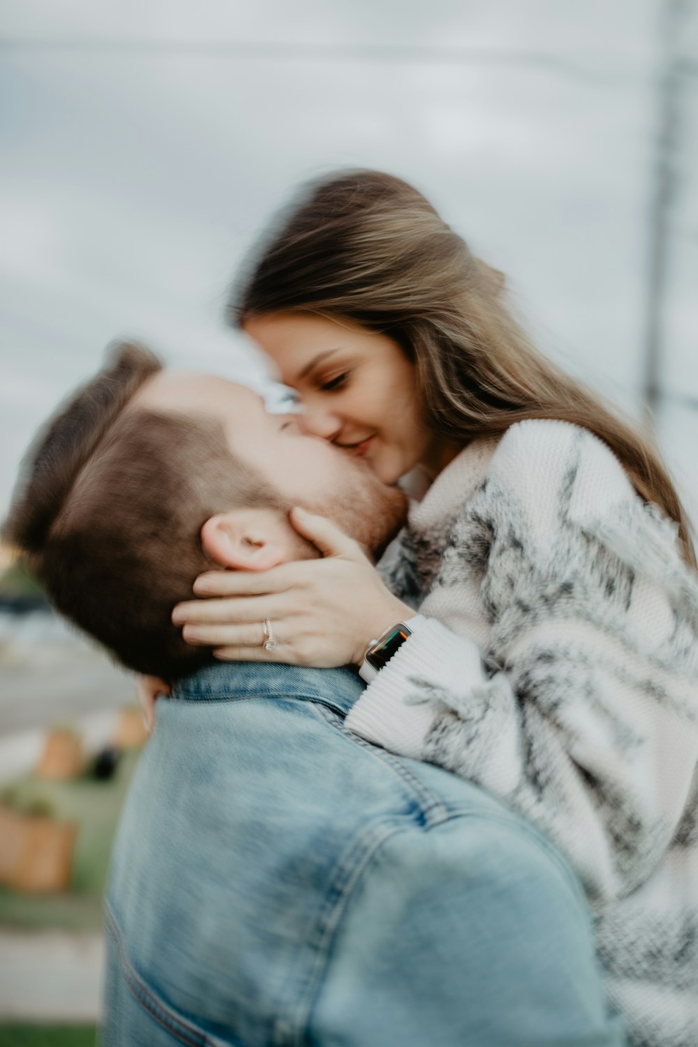 a man kissing a woman on the cheek