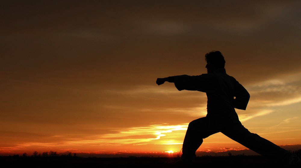 silhouette photography of man punching on air