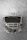 Close-up image of a sleek Kenny Hockey helmet resting on ice with a blurred rink background.