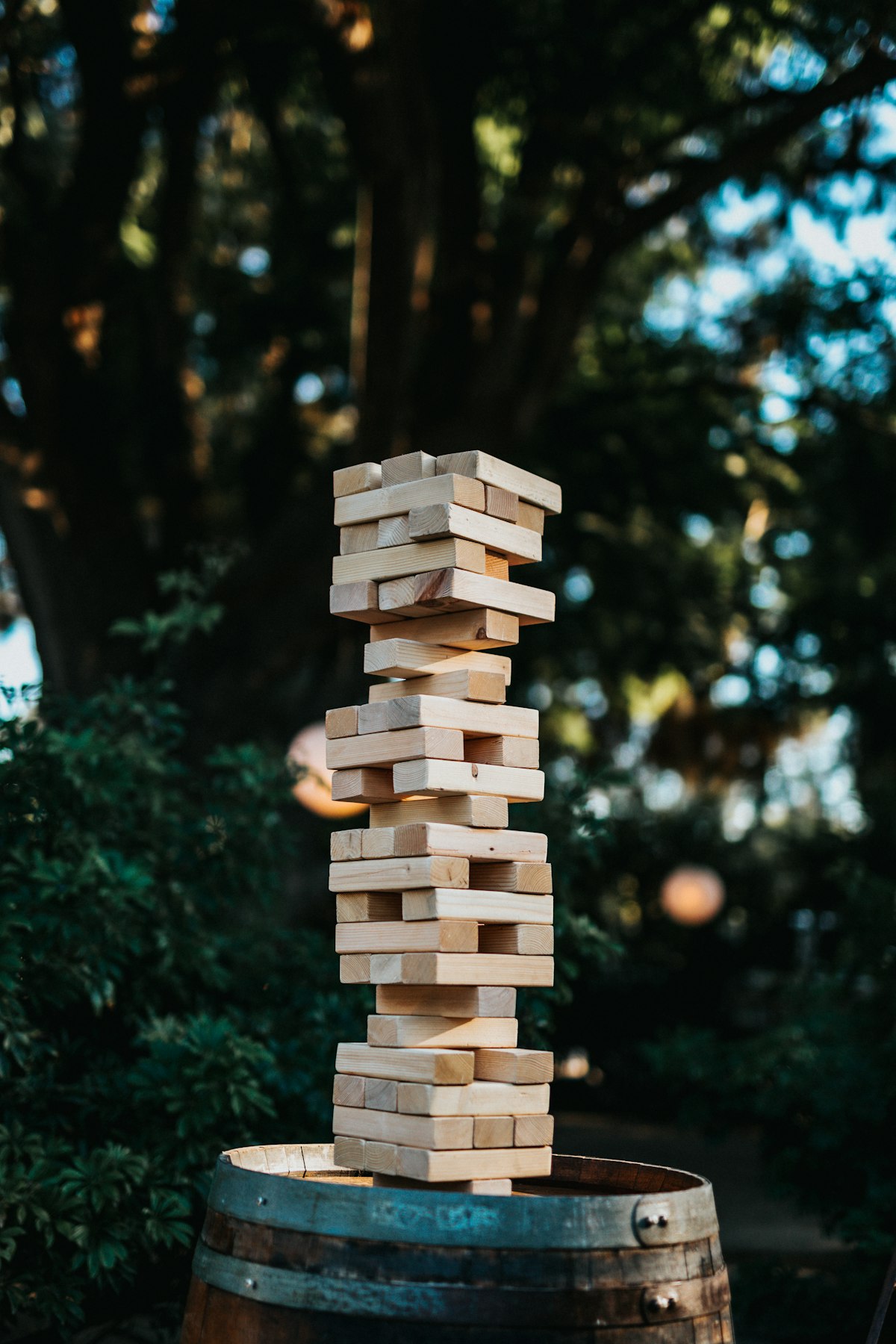 Giant Jenga lawn game set up in a garden at a summer wedding